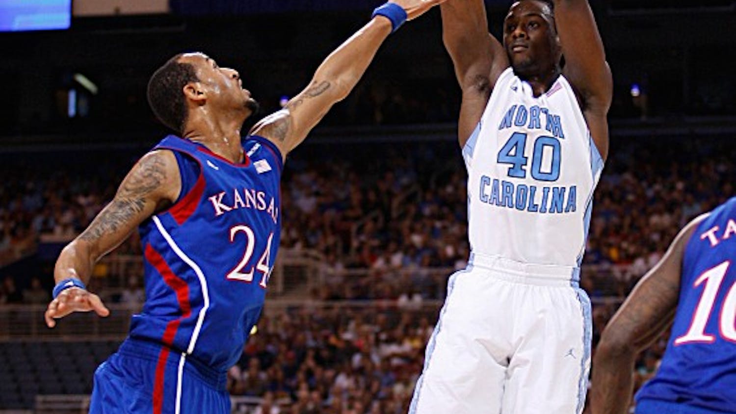 UNC forward Harrison Barnes shoots a jump shot as he is defended by Kansas guard Travis Releford. 