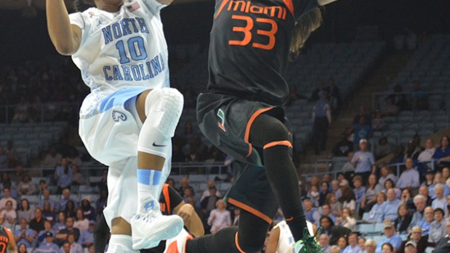 UNC guard Danielle Butts (10) makes a shot and draws a foul from Miami guard Suriya McGuire (33).