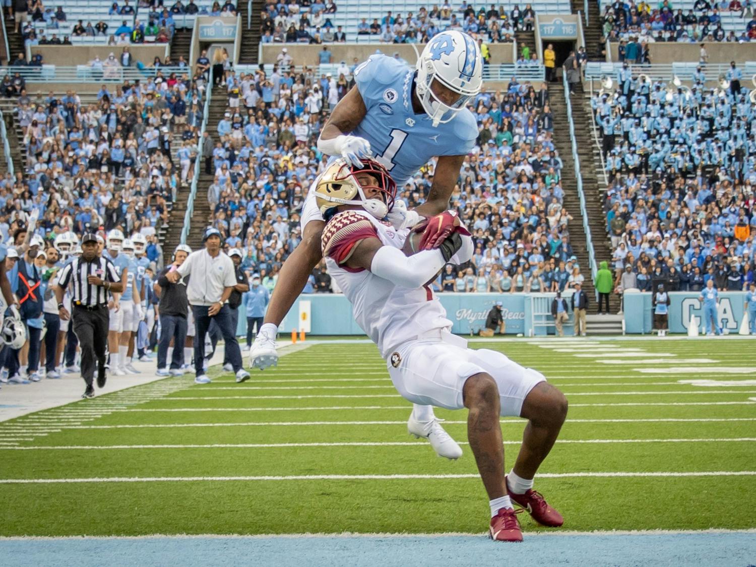 FSU sophomore defensive back Jarrian Jones (7) intercepts a long pass intended for UNC sophomore wide receiver Khafre Brown (1) during the Tar Heels' home football matchup in Kenan Memorial Stadium on Oct. 9, 2021, against the Florida State Seminoles. FSU won 35-25.