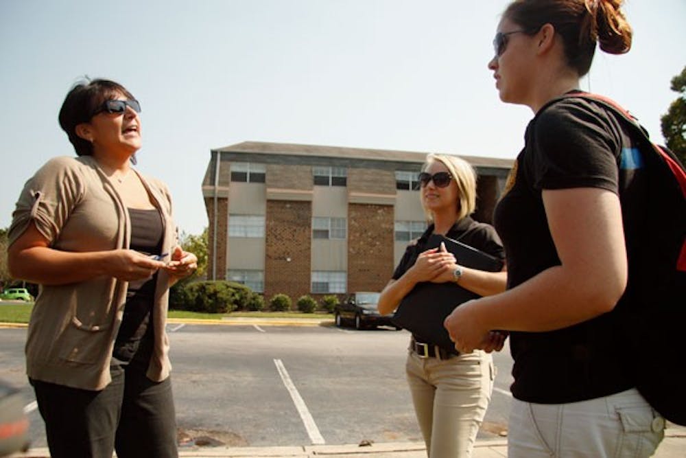 Elsa Ally Dena, left, property manager of Abbey Court Condominiums, chats with tenant Heather Monroe. DTH/Colleen Cook