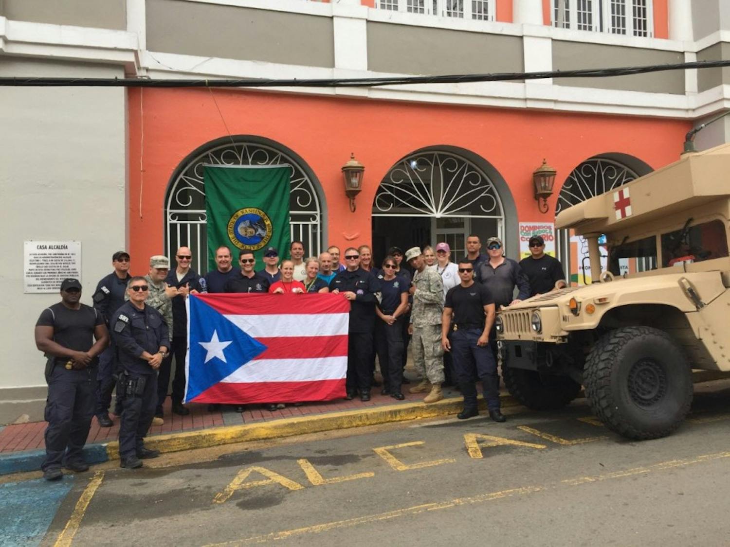 Jennifer Kelly and her team in Puerto Rico pose with Puerto Rican flag. They arrived in Puerto Rico to provide medical assistance and set up a clinic. Photo courtesy of Kelly.