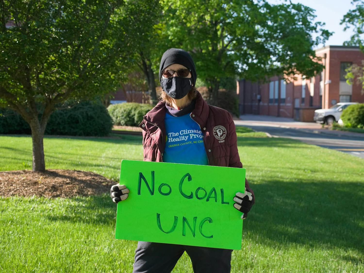 Margie Muenzer poses for a portrait in front of UNC's coal plant on Friday, Apr. 23, 2021.
