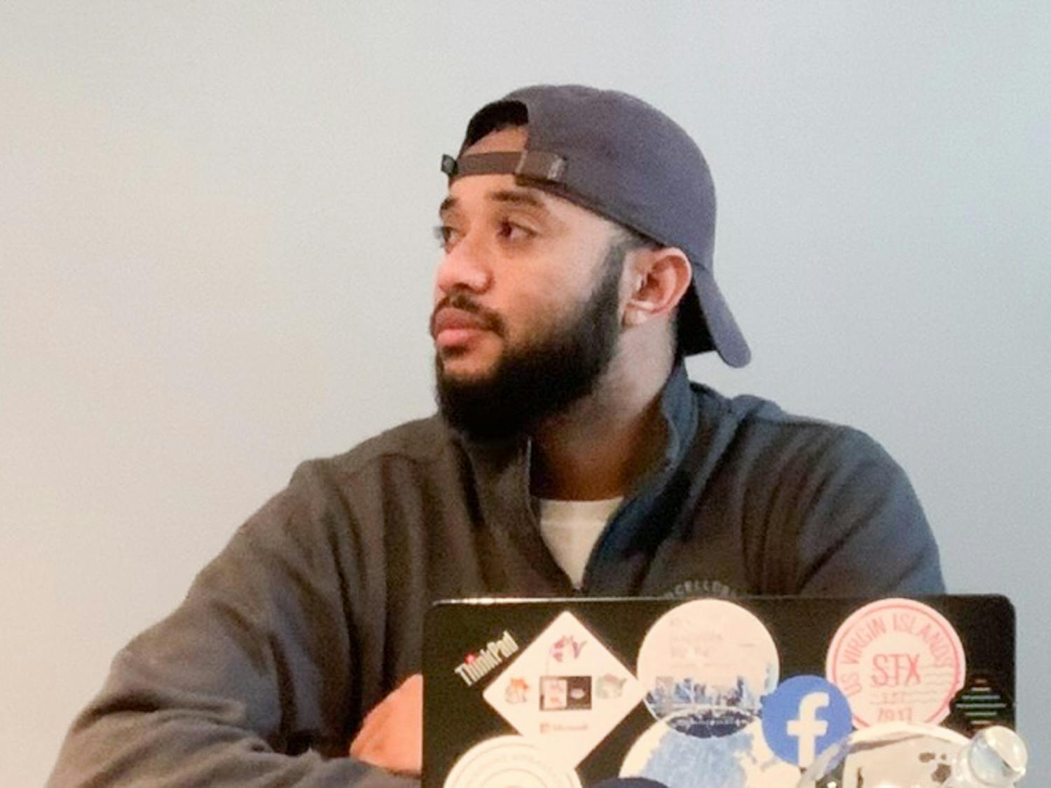 Former UNC student, Charlie Helms poses for a virtual portrait with his old college laptop in his Seattle apartment on Jan. 27, 2021. Helms co-founded Black in Technology, an organization dedicated to helping students of color in Computer Science.