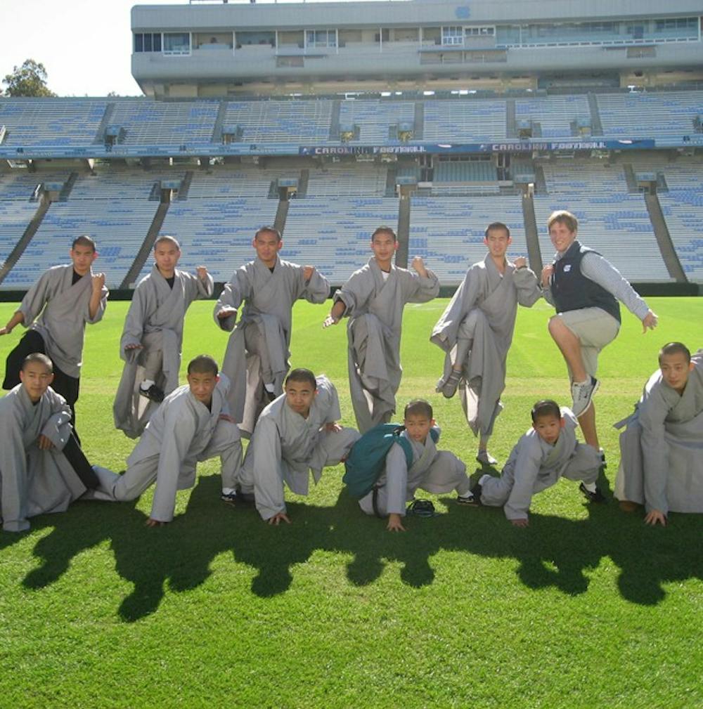 	<p>Junior Patrick Spaugh poses with the Shaolin Monks of “Sutra” as they tour <span class="caps">UNC</span>, one of two spots in which “Sutra” will perform in the U.S.</p>