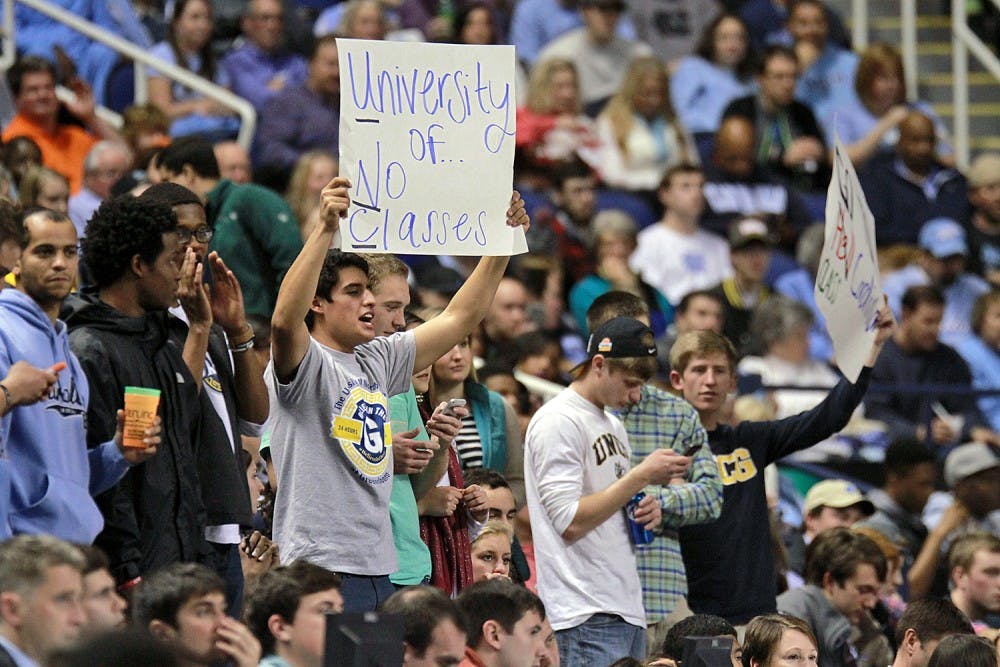 <p>UNC-Greensboro fans held signs mocking UNC's athletic-academic scandal.</p>