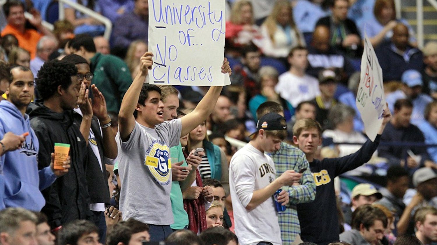 UNC-Greensboro fans held signs mocking UNC's athletic-academic scandal.
