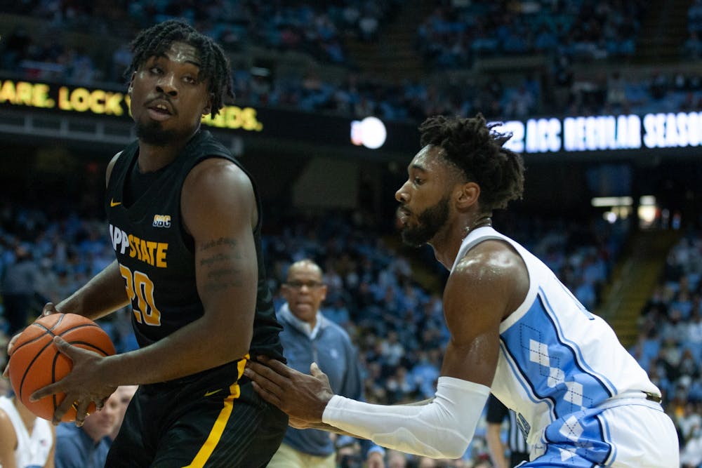 <p>Senior forward Leaky Black (1) guards an Appalachian State player at the game on Dec 21, 2021 at the Dean E. Smith Center. UNC won 70-50.</p>