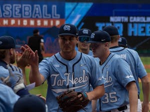 Junior pitcher Jake Knapp enters the dugout after an inning &nbsp;against the University of Virginia on Thursday, May 25, 2023. The Diamond Heels won 10-2.&nbsp;
