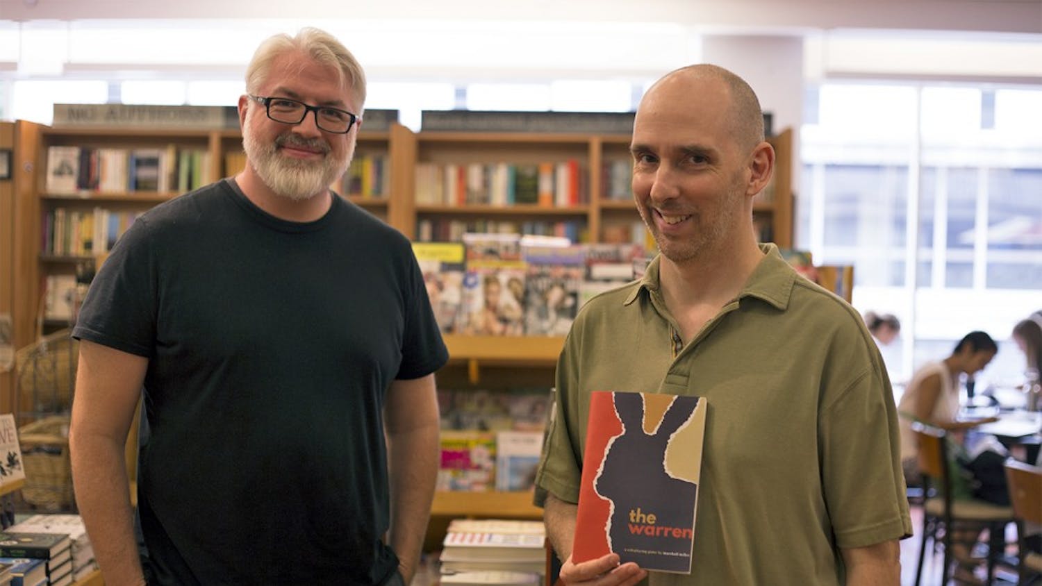 Steve Segedy (left) and Jason Morningstar, application analysts at UNC, stand in Bullhead's Bookshop with some of the books they have written. The two have recently developed Warren, a role-playing game based on the classic novel Watership Down. 
