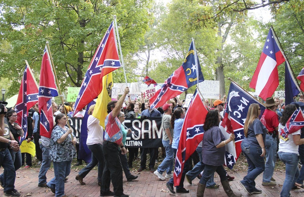  Confederate heritage supporters rallied in McCorkle Place to defend the statue of Silent Sam on Sunday. A protest against the statue went on at the same time. 