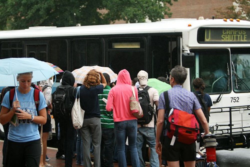 Students wait to board a bus Tuesday on South Road on World Carfree Day. DTH/B.J. Dworak