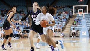 UNC junior guard Deja Kelly (25) dribbles the ball during the women's basketball game against TCU on Saturday, Nov. 11, 2022, at Carmicheal Arena. UNC beat TCU 75-48.