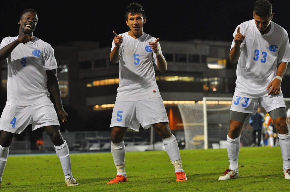 	UNC Sophomore Mikey Lopez (5) dances with Sophomore Boyd Okwuonu (15) and Freshman Raby George (33) after Mikey scored the game winning goal in the second overtime period. 