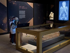 Visitors at the North Carolina Museum of Art explore the Golden Mummies of Egypt exhibit. Photo courtesy of the NCMA.