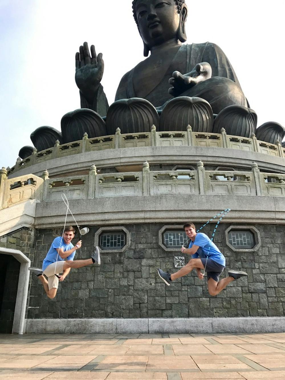 Jumping in front of statue 