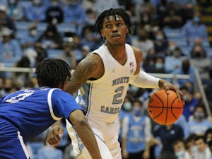 UNC sophomore guard Caleb Love (2) looks for a clear pass during UNC men's basketball's 72-53 win against UNC Asheville on Tuesday, Nov. 23, 2021, in the Dean E. Smith Center. 