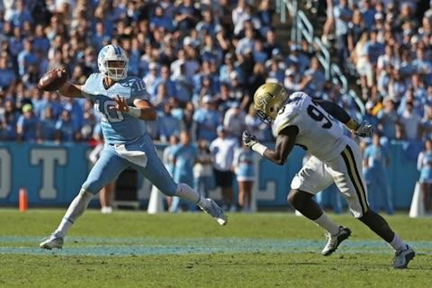UNC quarterback Mitch Trubisky (10) attempts a pass under pressure&nbsp;in a 48-20 win over Georgia Tech on Nov. 5. Trubisky will forgo his senior season and&nbsp;enter the 2017 NFL Draft.