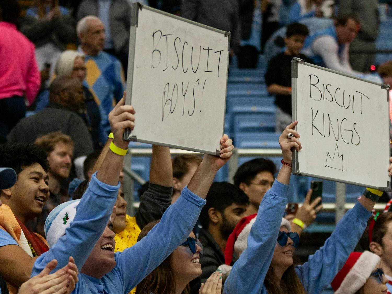 UNC students hold up signs that read "Biscuit Boys" and "Biscuit Kings" after the men's basketball game against The Citadel at the Dean Smith Center on Tuesday, Dec. 13, 2022. UNC beat The Citadel 100-67.