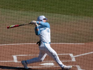 UNC first-year outfielder Will Stewart (12) swings at a pitch during UNC's 7-4 win over James Madison at Boshamer Stadium, Feb. 20, 2021.