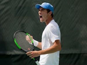 First-year Ben Sigouin celebrates during a match against Virginia on April 1 at the Cone-Kenfield Tennis Center.