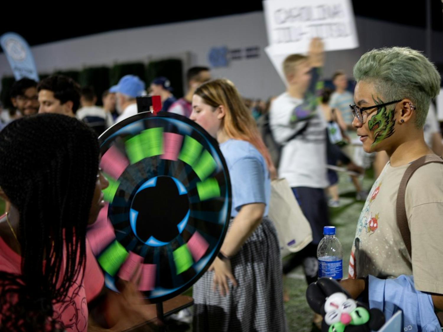 Jade Hampton, a senior information and library science major, spins a wheel for a prize during Fallfest on Hooker Fields on the evening of Sunday, August 18 2019.