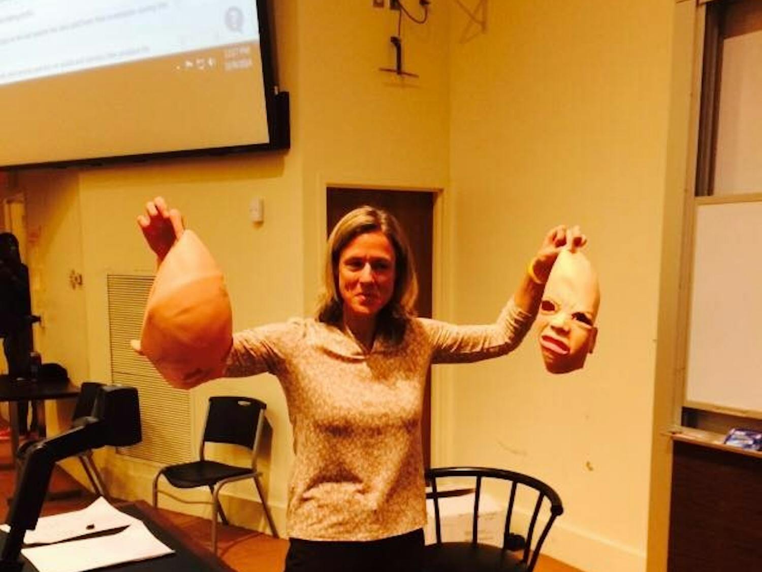 Professor Rita Balaban stands with the two masks she removed from streakers who interrupted her class on Thursday.