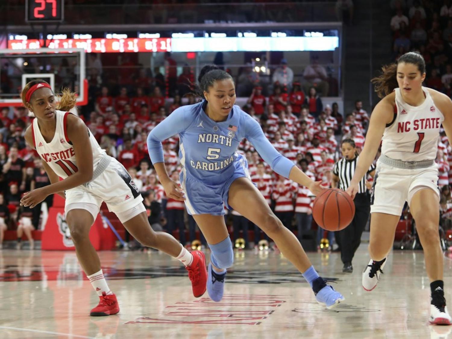 Tar Heel redshirt junior guard Stephanie Watts (5) steals the ball from Wolfpack junior guard Aislinn Konig (1) during UNC's 64-51 win against NC State at Reynolds Coliseum on Sunday, Feb. 3, 2019 in Raleigh, NC. The Tar Heels Women's Basketball Team (14-9) handed the Wolfpack (21-1) their first loss of the season.