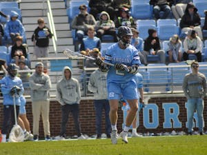 Graduate midfielder Henry Schertzinger (2) cradles the ball during the men's lacrosse game against Brown at Dorrance Field on Saturday, March 11, 2023. UNC won 19-6.