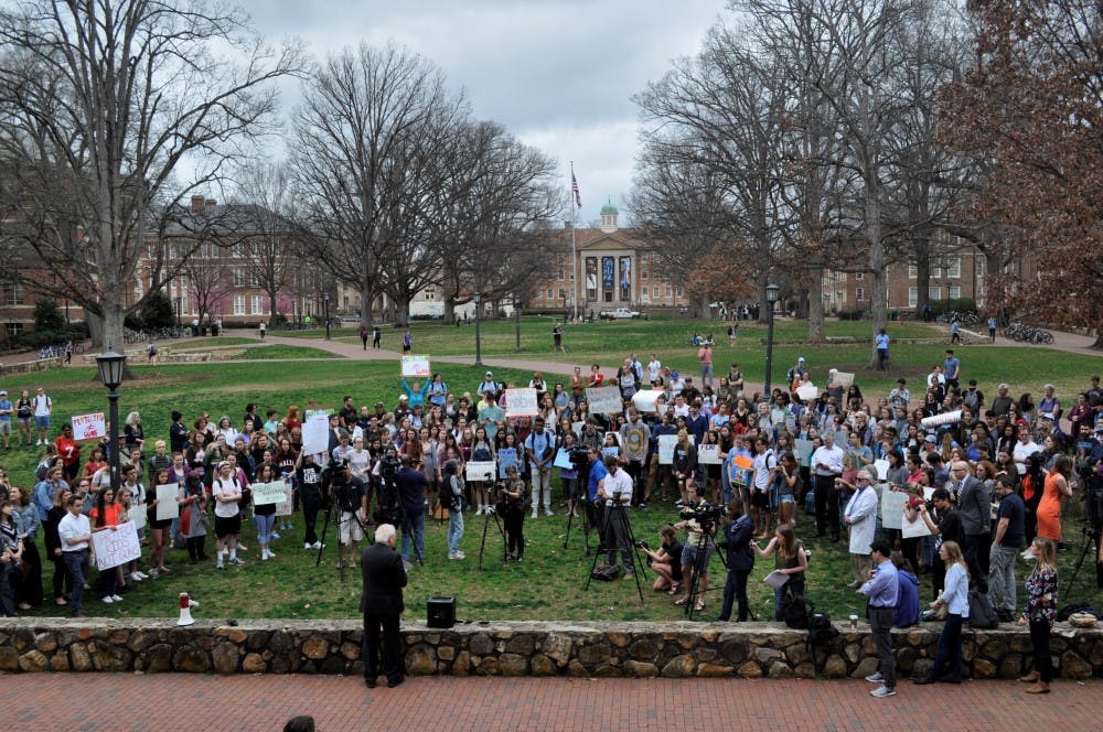 <p>Students gather in front of Wilson Library to protest gun violence on Thursday morning.</p>