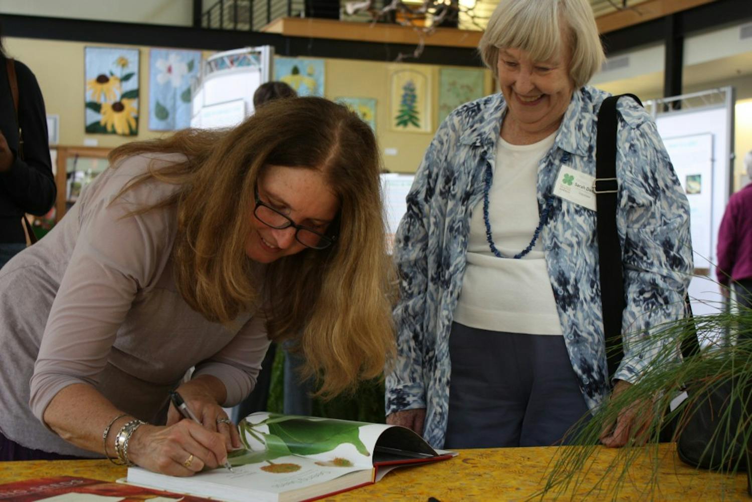 Sarah Dendy of Durham has her copy of "Seeing Seeds" signed by Teri Dunn Chace. 