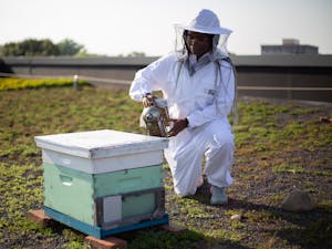 Junior biochemistry major Adrienne Lambert demonstrates how to use a smoker on a beehive on Monday, Aug. 23, 2021. Lambert is the president of the Carolina Beekeeping Club.