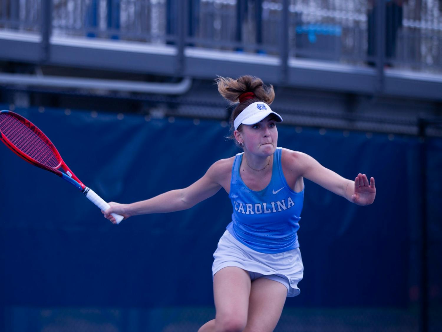 UNC junior Fiona Crawley swinging the racket at a match against the Florida State University Seminoles at the Cone-Kenfield Tennis Center on Friday, March 31, 2023. The Tar Heels won 6-1.