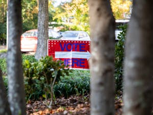 Voting signs cover the lawn outside Holy Trinity Lutheran Church on Election Day, Nov. 2, 2021.