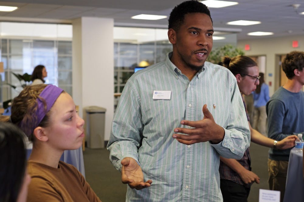 Keelon Dixon discusses with students at the Carolina Pulse event Tuesday evening.
