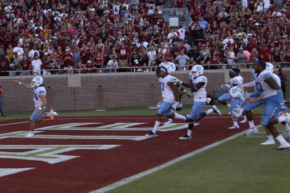 UNC kicker Nick Weiler (24) imitates the Florida State "Tomahawk Chop" as he celebrates kicking a career high 54-yard field goal as time expired to lift UNC over Florida State.