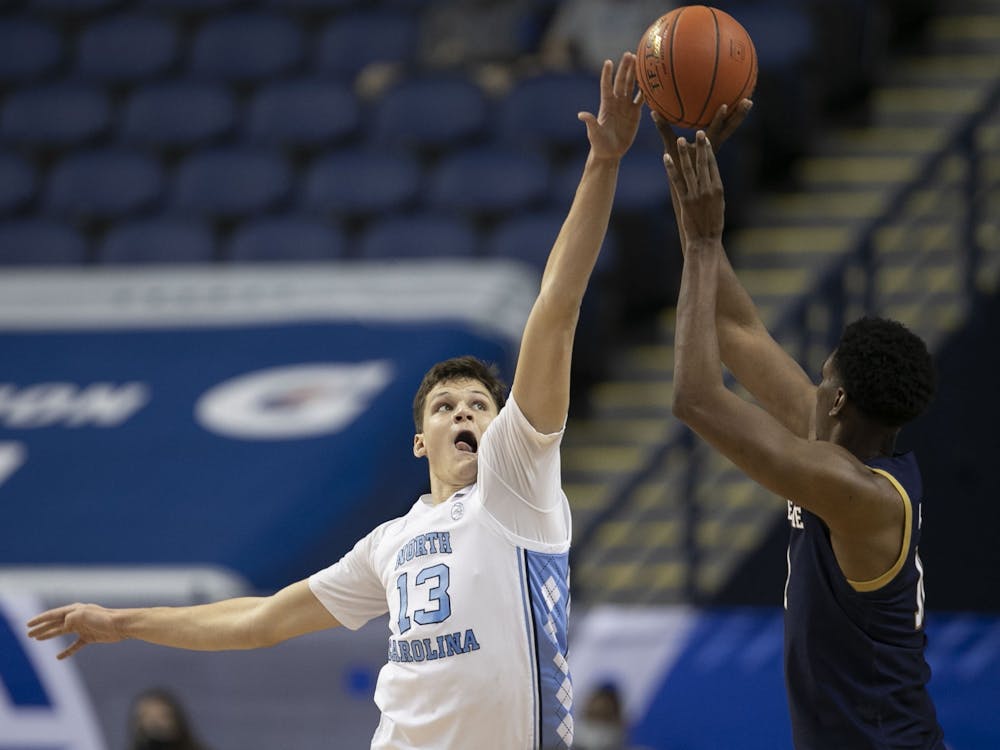 North Carolina Walker Kessler (13) blocks a shot by Notre Dame’s Juwan Durham (11) in the second half on Wednesday, March 10, 2021 during the ACC Tournament at the Greensboro Coliseum in Greensboro, N.C. Photo courtesy of Robert Willett.