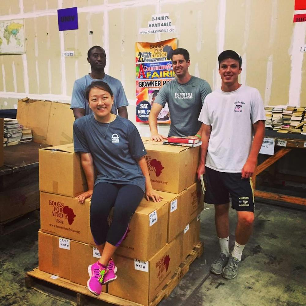 Christine Bang, left, Rob Jones, center, and Alex Hoffman, right, lead a Books for Africa Service Day.