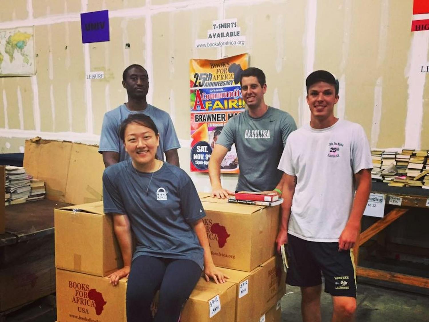 Christine Bang, left, Rob Jones, center, and Alex Hoffman, right, lead a Books for Africa Service Day.