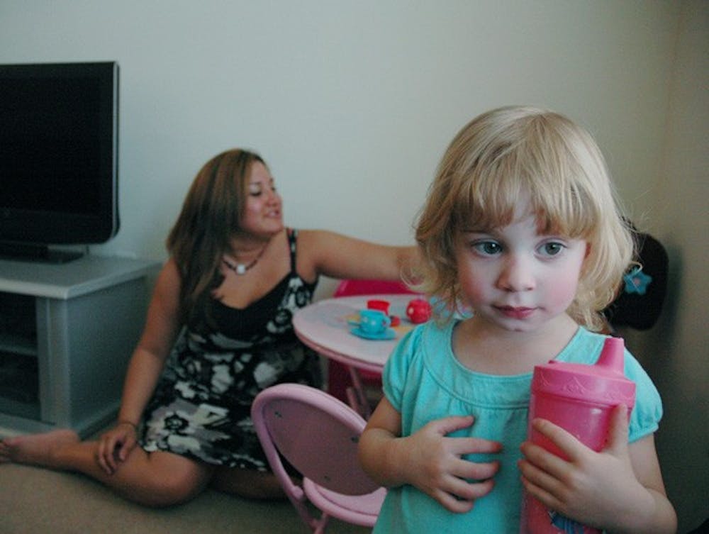 Christina Kaemmerlen plays with her two-year-old daughter, Isabelle, in her student housing apartment. DTH/ Ben Pierce