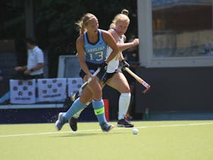 Senior defender Ashley Hoffman (13) boxes out a defender during UNC's 2-1 win over Iowa at Carolina Field Hockey Stadium on Aug. 26.