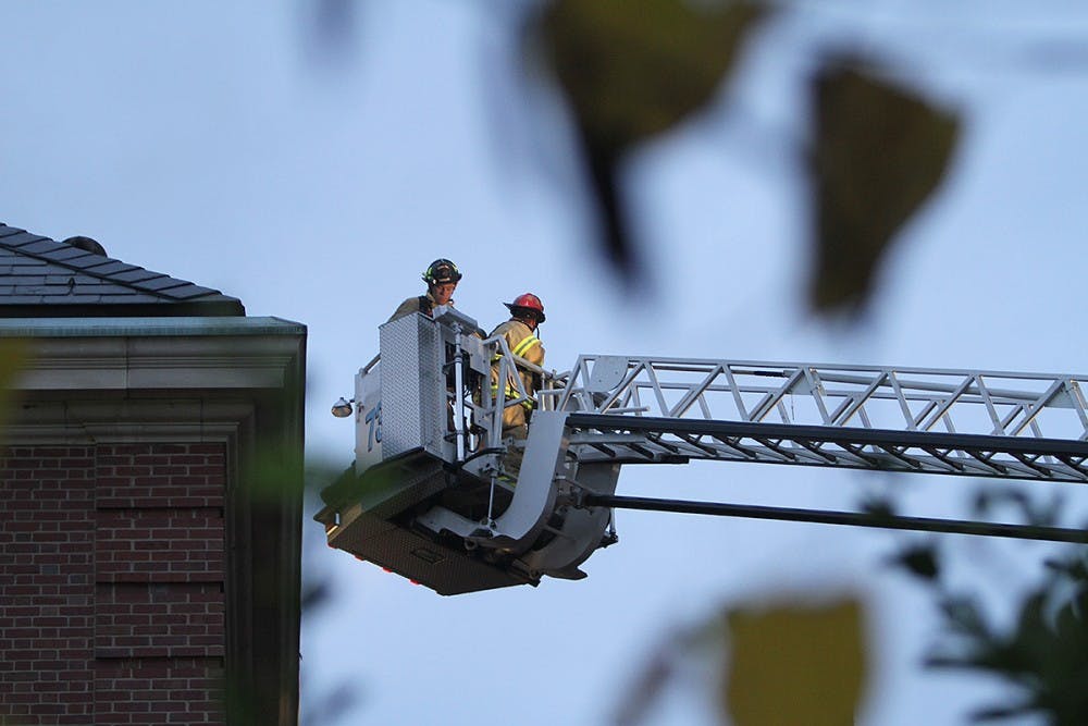	Firefighters work to put out flames at Cobb Residence Hall on Nov. 5. The fire was contained to the attic and fourth floor of Cobb.