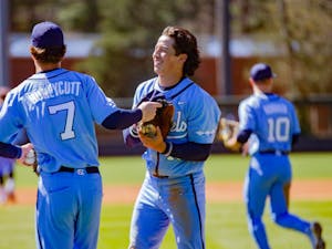 Redshirt junior outfielder Angel Zarate (40) smiles with his teammate Vance Honeycutt (7) at the game against Pittsburgh on March 13, 2022 at Boshamer Stadium.