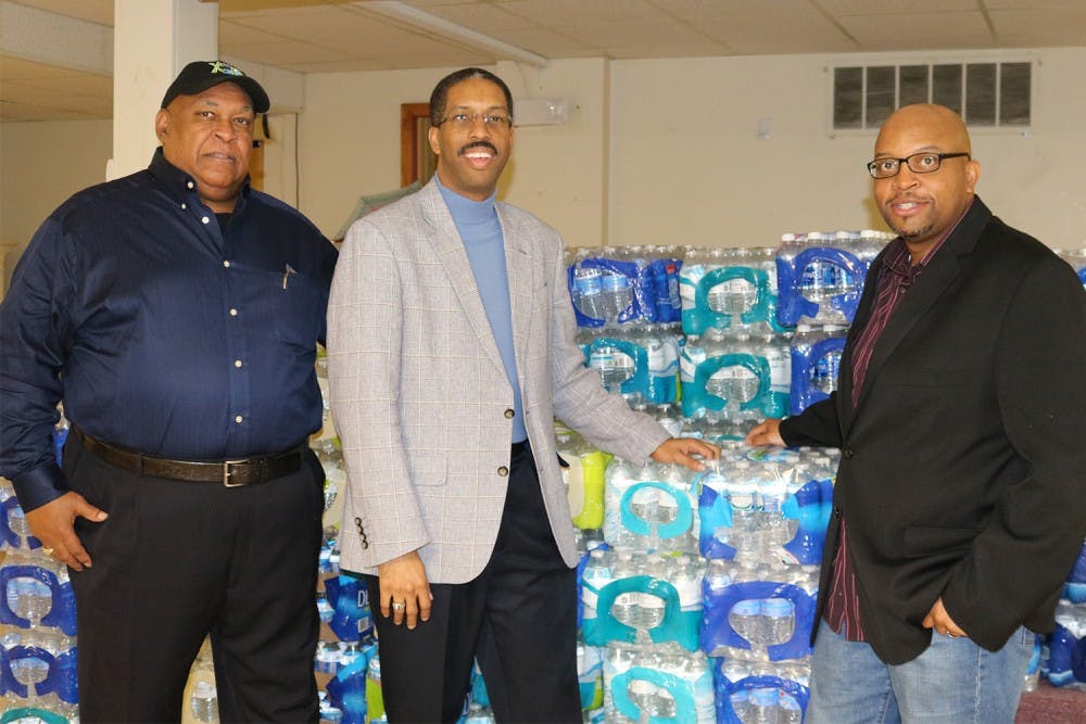 [left to right] Ken Davis, Jace Cox, and Reverend Coleman are collecting donations of bottled water.
