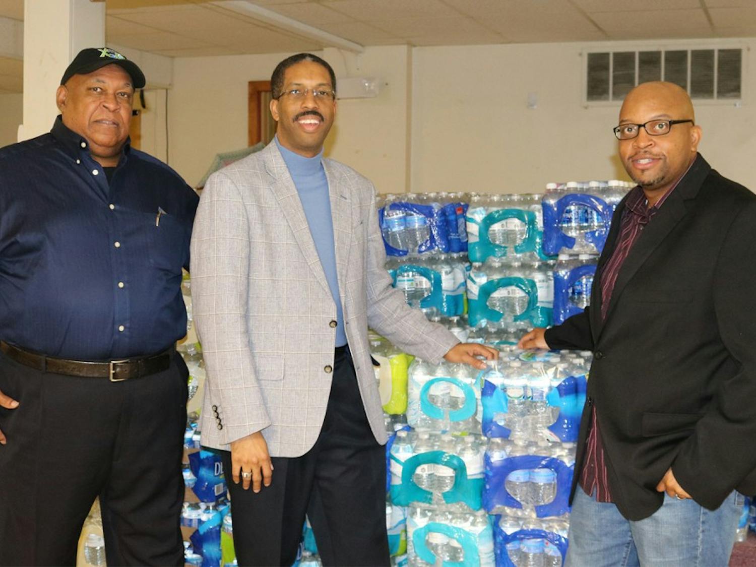[left to right] Ken Davis, Jace Cox, and Reverend Coleman are collecting donations of bottled water.