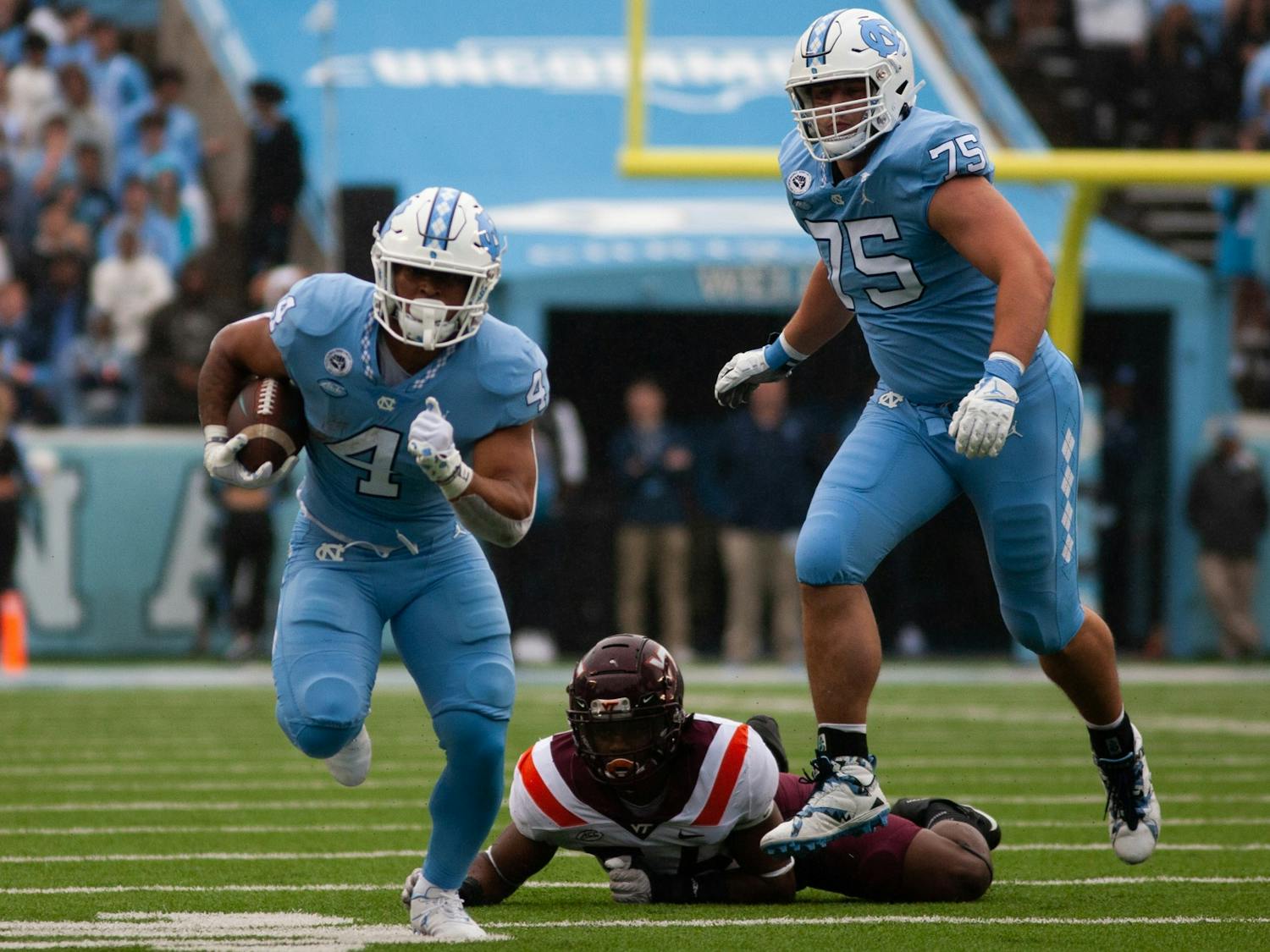 UNC sophomore running back Caleb Hood (4) runs past a tackle during a home football game at Kenan Stadium against Virginia Tech on Saturday, Oct. 1, 2022. UNC won 41-10.