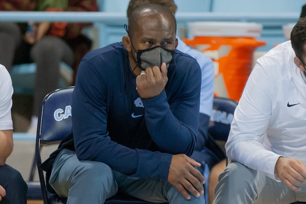 Assistant coach of the UNC wrestling team Jamill Kelly watches his players compete at the wrestling match against Queens University on Nov. 1 at Carmichael Arena.