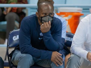 Assistant coach of the UNC wrestling team Jamill Kelly watches his players compete at the wrestling match against Queens University on Nov. 1 at Carmichael Arena.