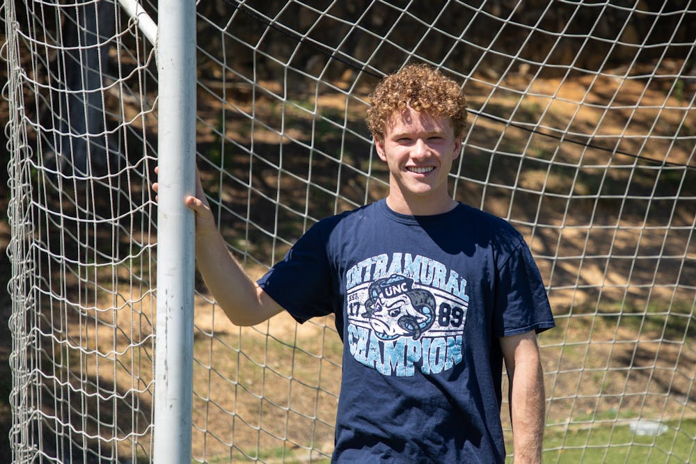 <p>Andrew Zadrozny, a rising junior studying computer science, poses for a portrait in his intramural soccer championship t-shirt at Hooker Fields on Saturday, June 18, 2022.</p>