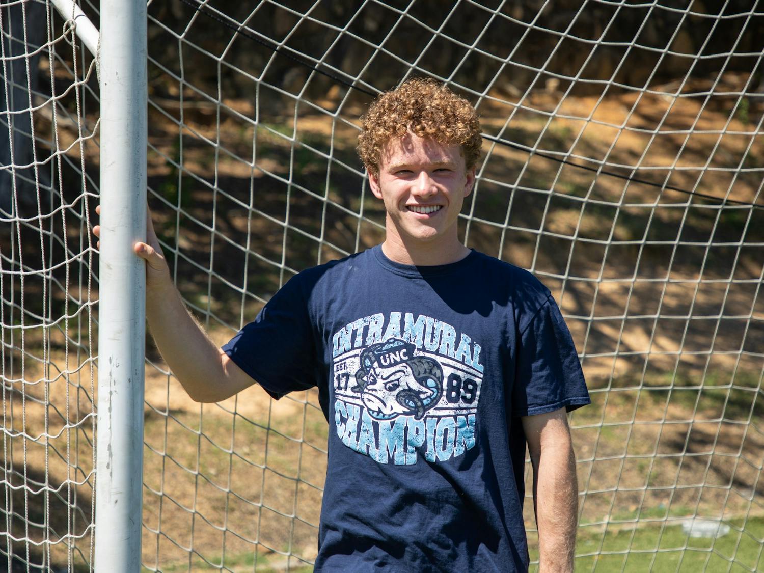 Andrew Zadrozny, a rising junior studying computer science, poses for a portrait in his intramural soccer championship t-shirt at Hooker Fields on Saturday, June 18, 2022.