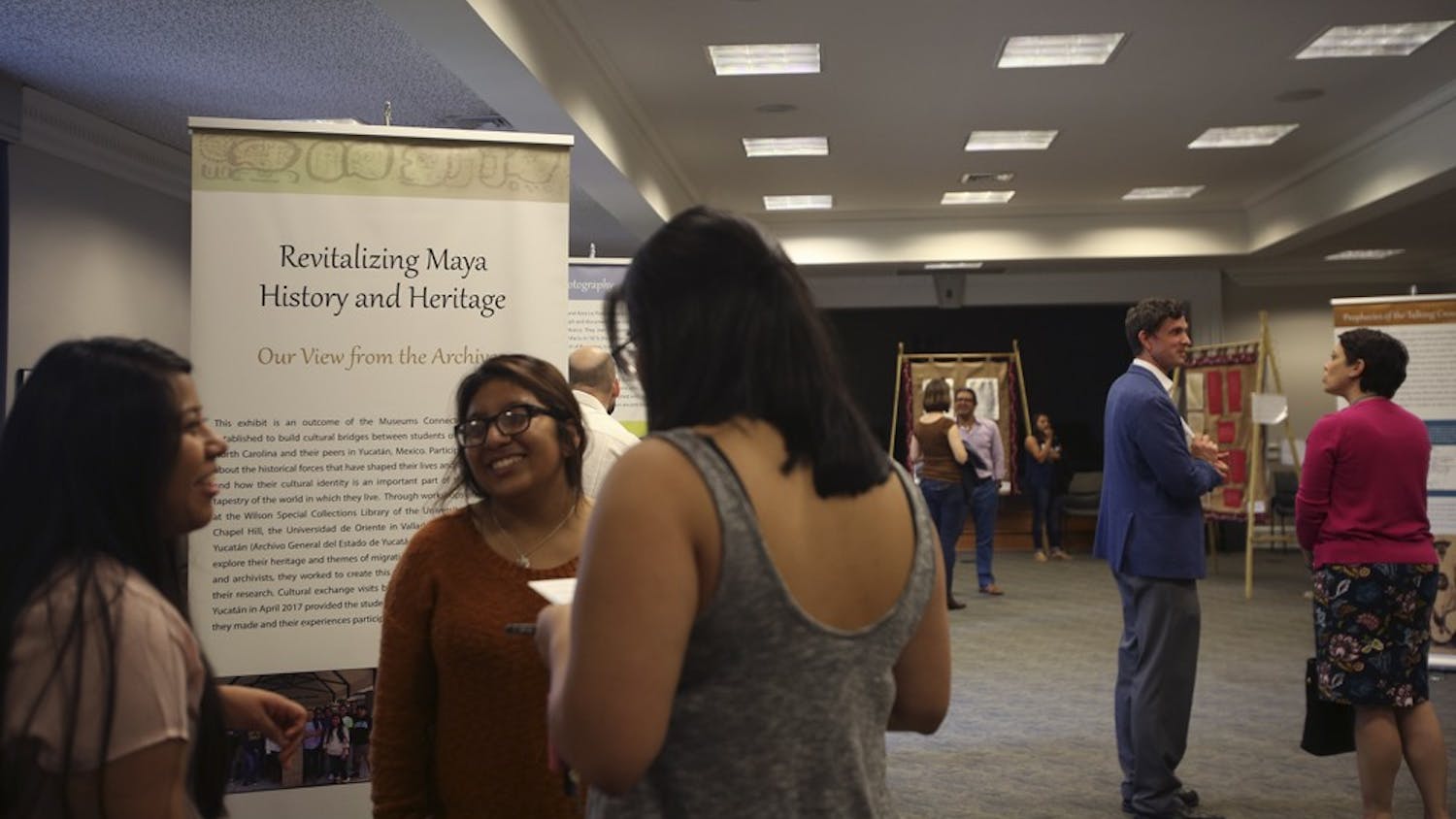 People came to the reception of the Mayan exhibit curated by high schoolers from Morganton, NC and Mexico, displayed in the Wilson Special Collections Library on Friday, April 14.